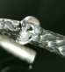 Photo9: Twelve Small Skull On 7.5mm Chiseled Wire O-ring Bangle