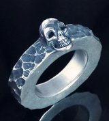 Twelve Small Skull On 6.5mm Wide Side Flat Chiseled Ring Bold